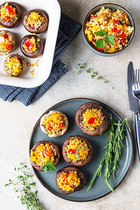 Baked stuffed portobello mushrooms with bulgur pilaf and chopped vegetables. 