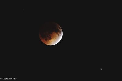 Low angle view of moon against clear sky at night