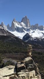 Scenic view of snowcapped mountains against clear sky