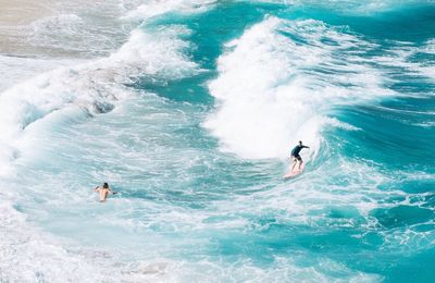 People surfing in sea