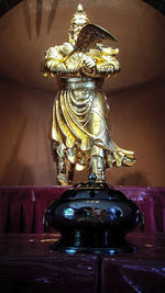 Close-up of statue on table at home