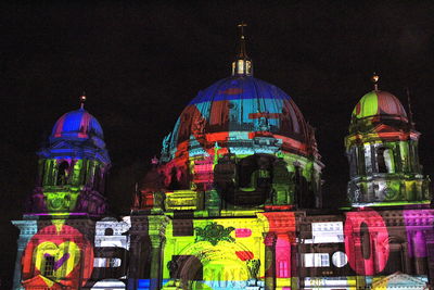 Illuminated building in city at night