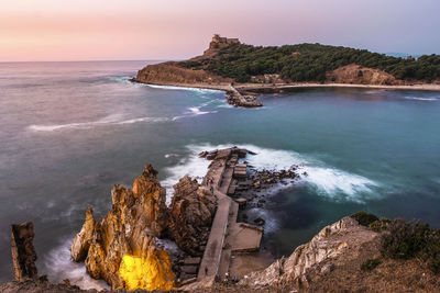 Panoramic view of rocks on beach against sky