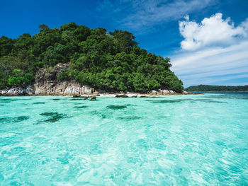 Scenic view of crystal clear turquoise sea against summer blue sky near koh lipe island, thailand.