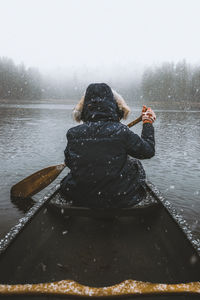 Rear view of man in rowboat