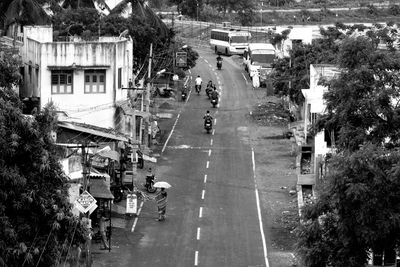 People and vehicles on road by buildings