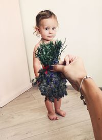 Mother holding flower against baby