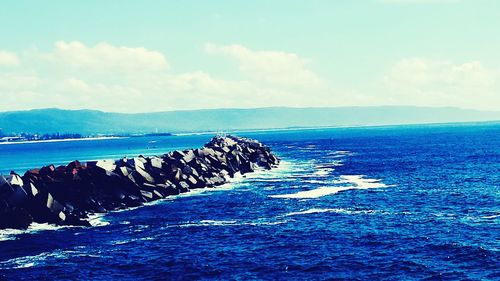 Scenic view of sea against cloudy sky