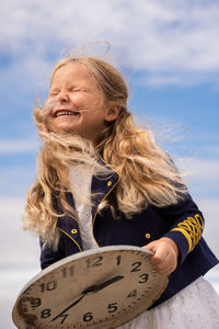 Portrait of girl against sky