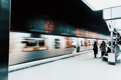 People walking on railroad station platform