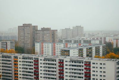 Buildings in city against clear sky