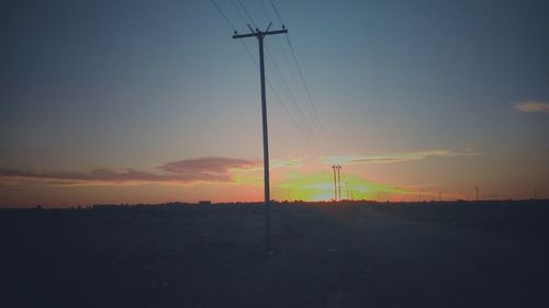 Silhouette of wind turbines at sunset