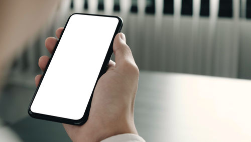 Close-up of hand holding mobile phone