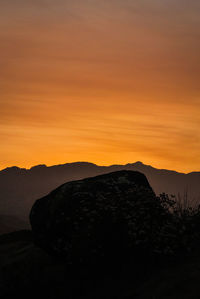 Scenic view of silhouette mountains against sky during sunset