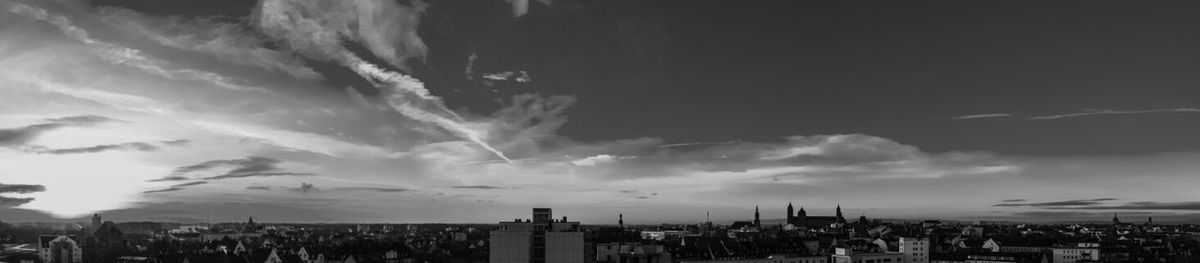 Cityscape against cloudy sky