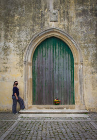 Side view of man sitting outside building