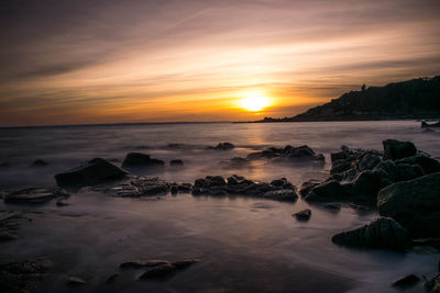 Scenic view of sea at sunset