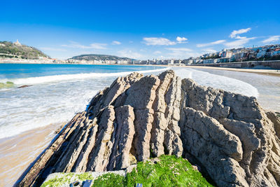 Scenic view of beach against blue sky