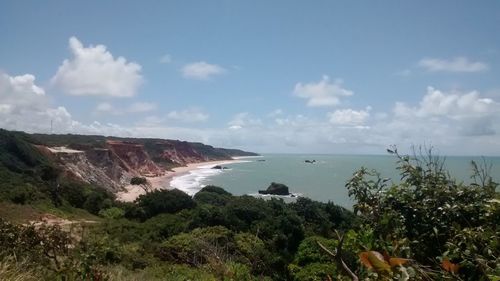 Scenic view of calm sea against cloudy sky