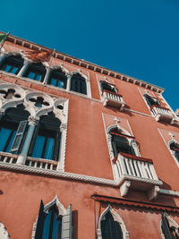 Low angle view of old building against blue sky