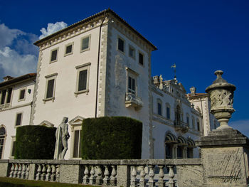 Low angle view of old building against clear blue sky