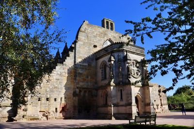 Low angle view of historical building against blue sky