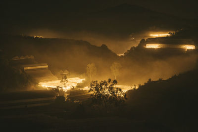 High angle view of illuminated greenhouses at night