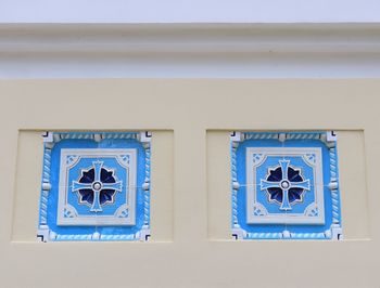 Low angle view of blue window on building