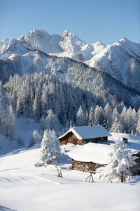 Beautiful winter mountain landscape with snowcapped wooden hut. austrian alps