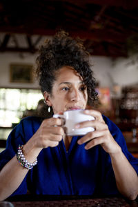 Relaxed woman drinking a cup of coffee,