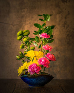 Close-up of potted plant on table against wall