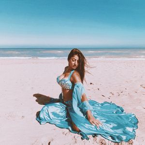 Young woman sitting on beach