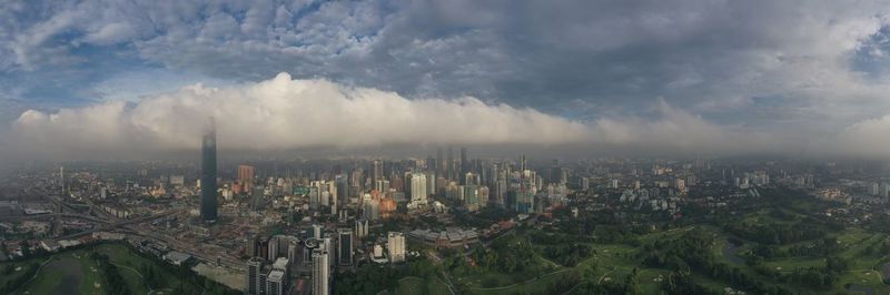 High angle view of modern buildings in city against sky