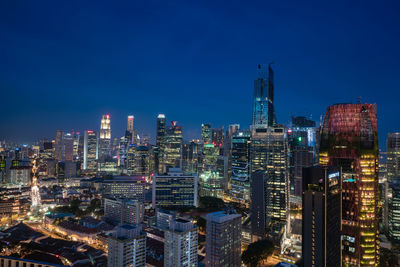 Aerial view of city lit up at night