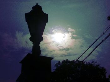 Low angle view of street light against building at sunset