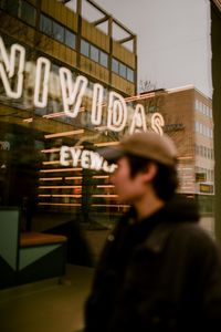 Portrait of man standing against built structure