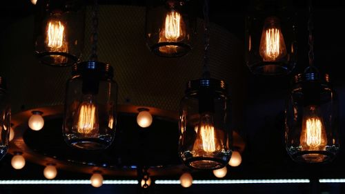 Close-up of illuminated candles on table