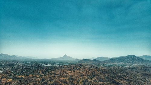 Scenic view of mountains against clear blue sky