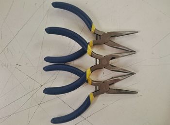 Directly above shot of pliers on table