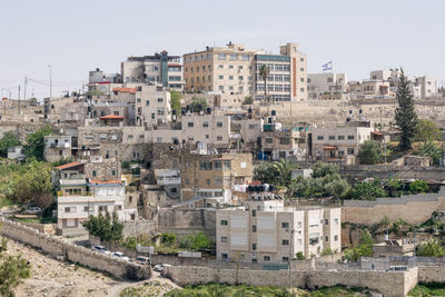 Buildings in city against clear sky