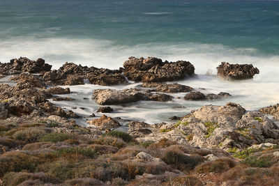 Rocks on beach against sky