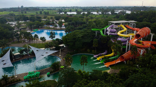 High angle view of swimming pool by river against sky