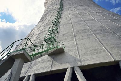 Low angle view of ladder by building against sky