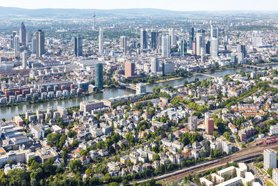 High angle view of modern buildings by river in city