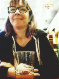 Close-up portrait of young woman drinking glasses