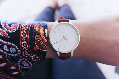 Low section of man wearing wristwatch