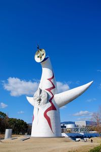 Low angle view of statue against blue sky