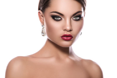 Close-up of young woman against white background