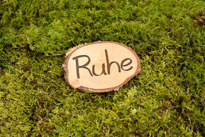 High angle view of information sign on grass