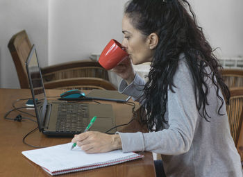 Woman using smart phone on table